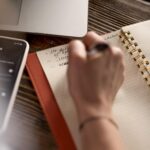 top-view-freelance-woman-taking-notes